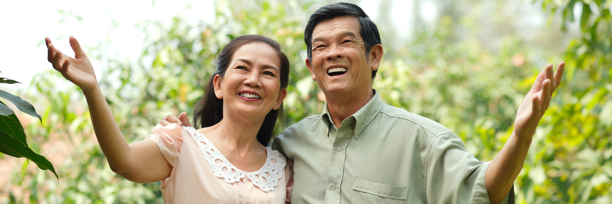 asian couple smiling in nature